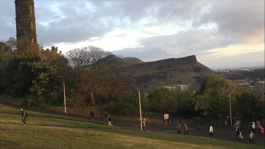 Some people walking up Calton Hill with Arthur's Seat in the background, Edinburgh, Scotland