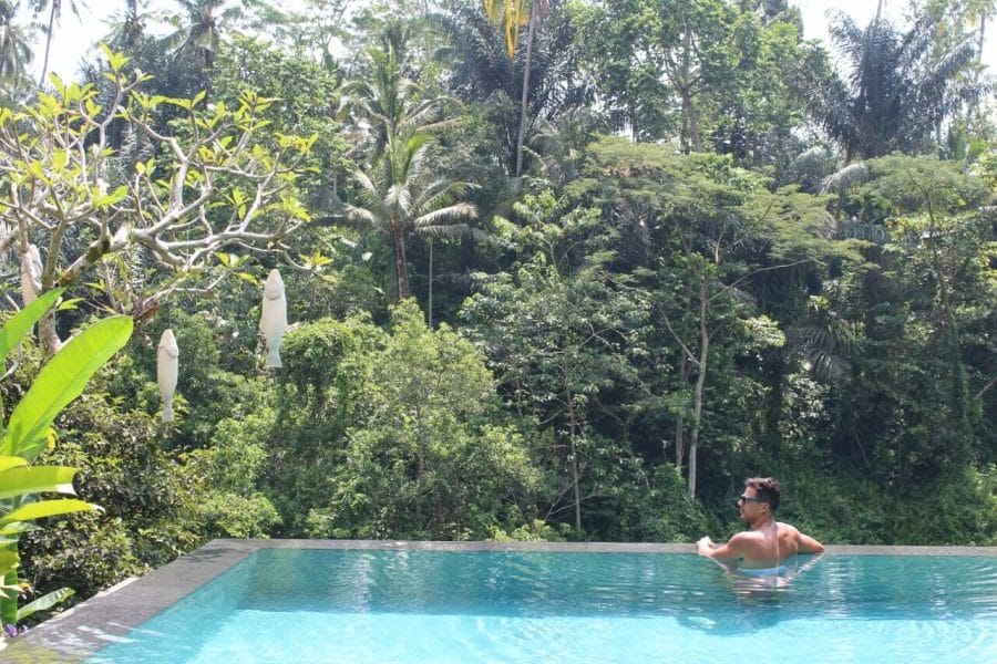Pericles Rosa in an infinity  swimming pool with trees kin the background at Jungle Fish Bali