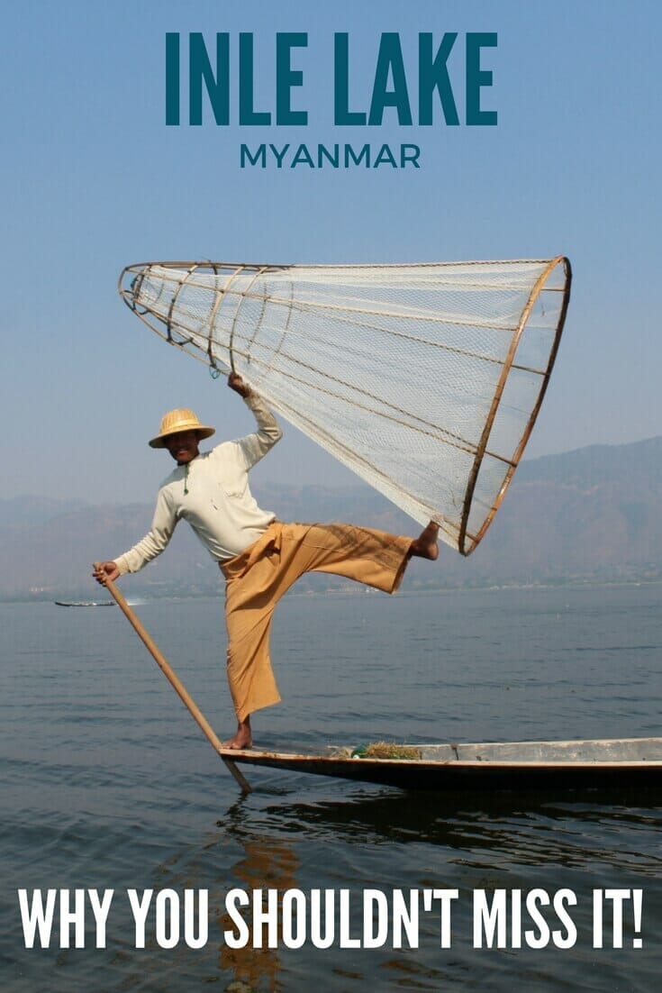 A fisherman standing with his legs wide open holding a conical basket at Inle Lake Myanmar