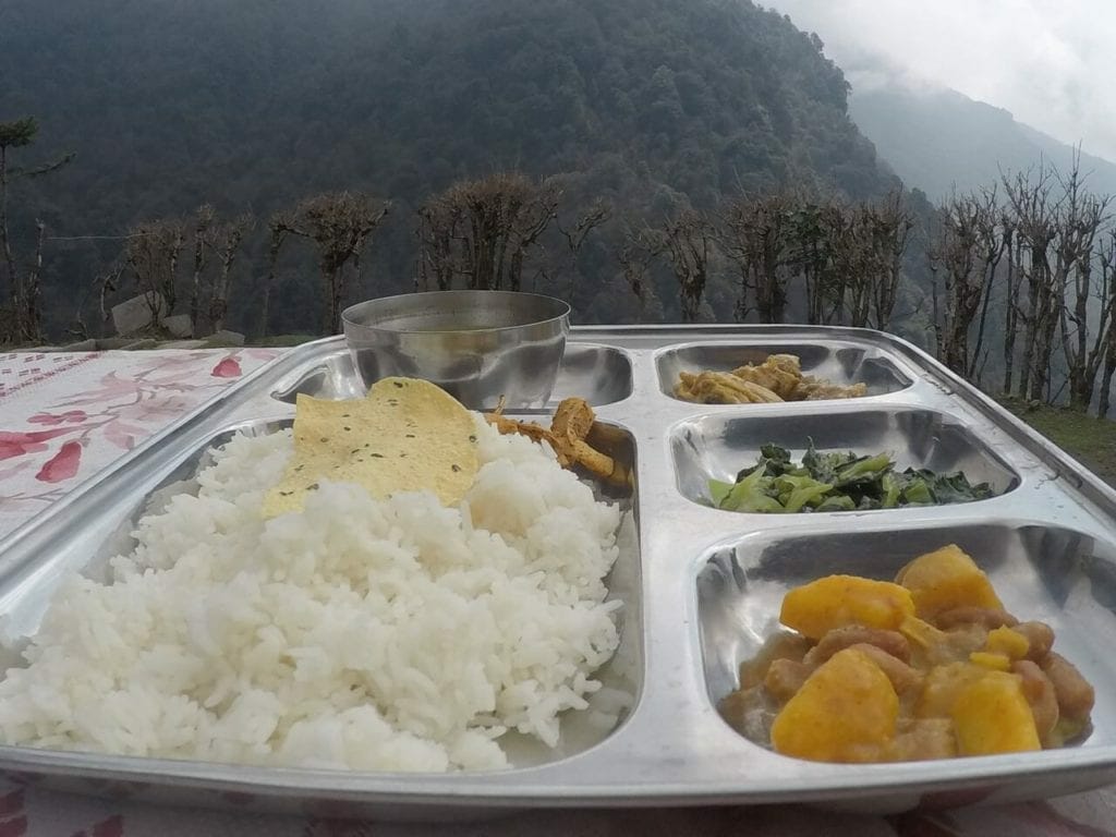 Lunch served on an aluminium plate at a restaurant in the village of Banthanti, Nepal, with rice, lentil soup, chicken, potatoes and beans