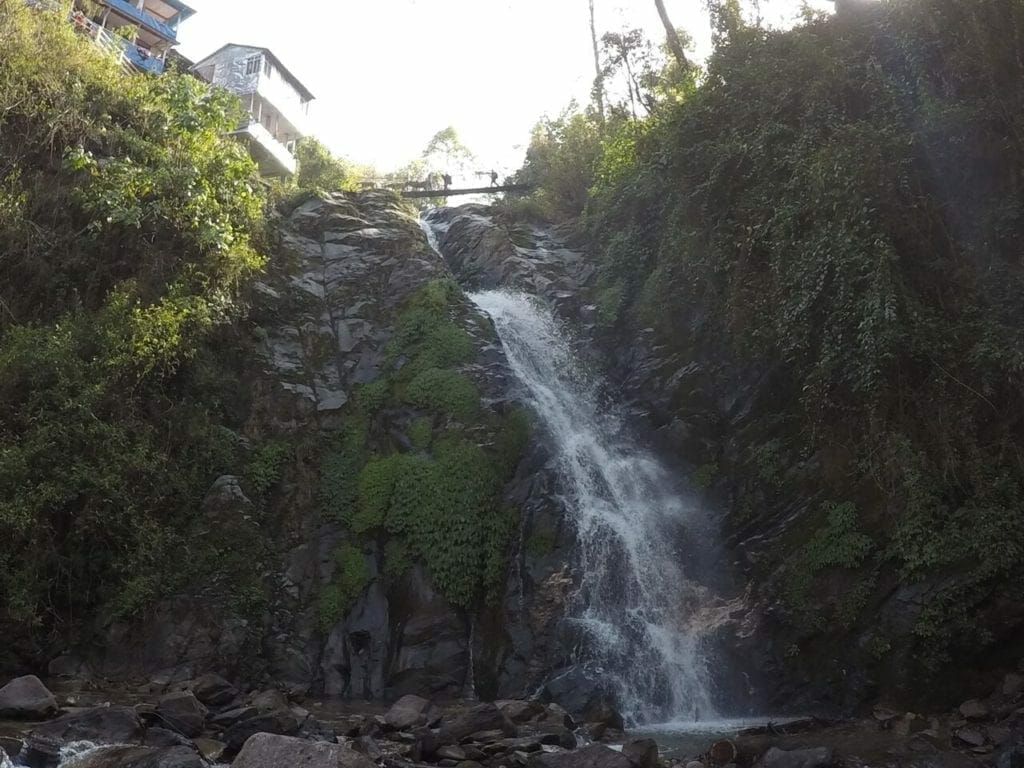A waterfall under a suspension bridge at Tikhedhunga.