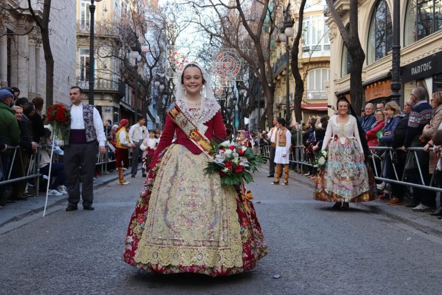 A charming and happy fallera mayor infantil during the flower parade.