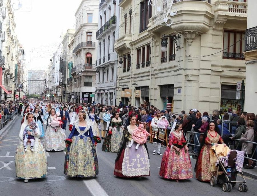 Thousands of falleros and falleras of all ages attend the Flower Offering Parade every year
