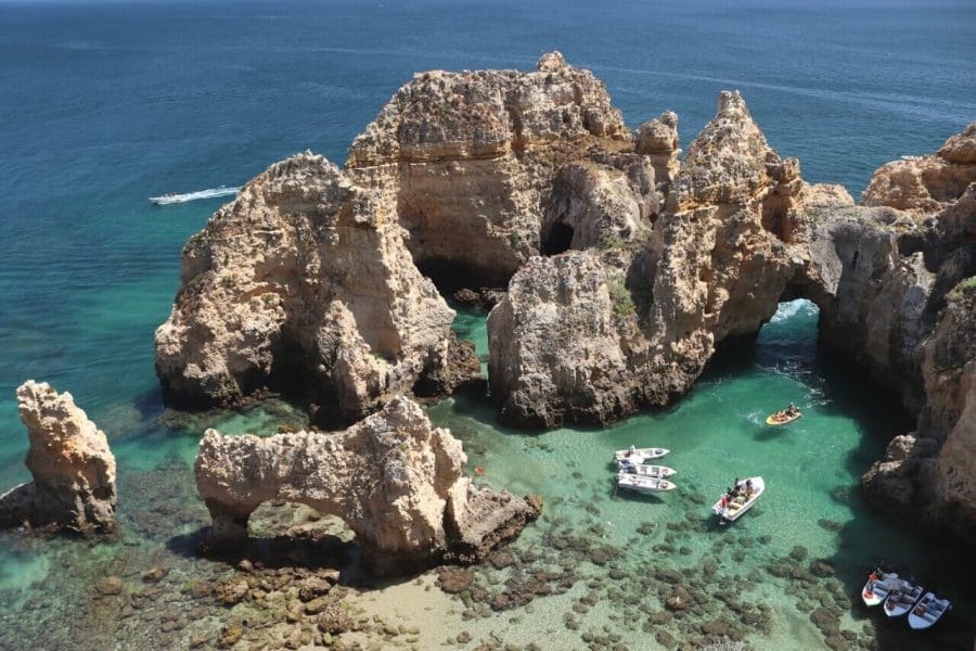 Ponta da Piedade, Lagos, and its ochre limestone cliffs with incredible rock formations, sea arches and some boats sailing along its crystal-clear green water
