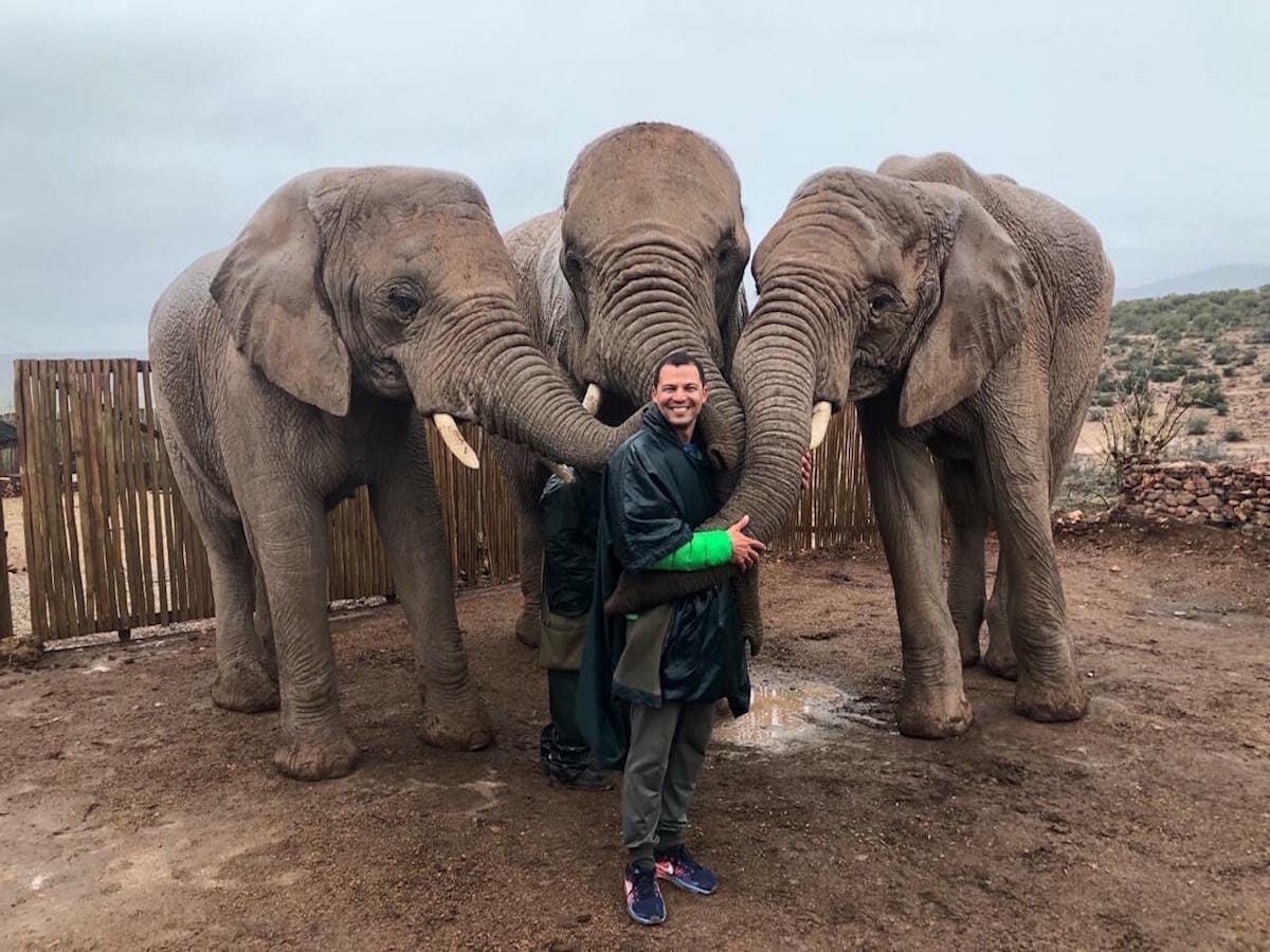 Pericles Rosa holding three elephant trunks at Buffelsdrift Loft, South Africa