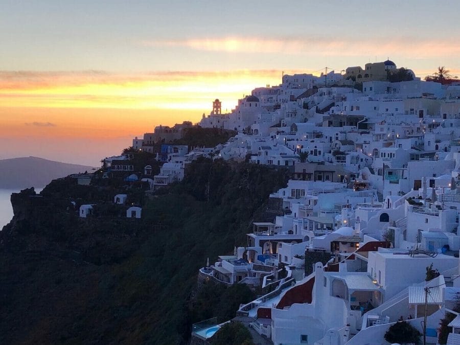 30 Amazing Things to Do in Santorini, Greece 19 Whitewashed houses on the top of a cliff in the village of Imerovigli, Santorini, during the sinset