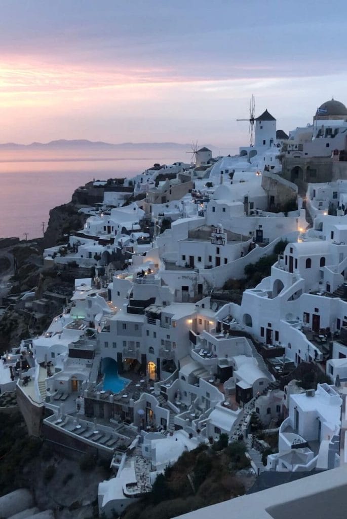 whitewashed houses in the town of Oia, Santorini, during the sunset