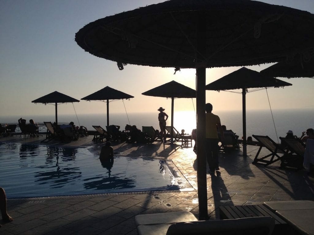 lounge chairs, umbrellas and a swimming pool at Lioyerma Lounge Cafe Pool Bar, Santorini