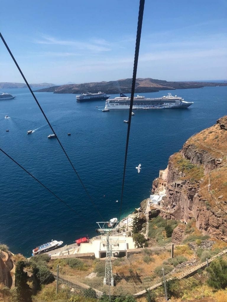 The view of two cruise ships, Nea Kammeni Island and the Aegean Sea from a Santorini's cable car