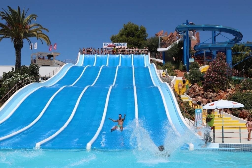 A man sliding down on a long water slide at Slide & Splash, Algarve
