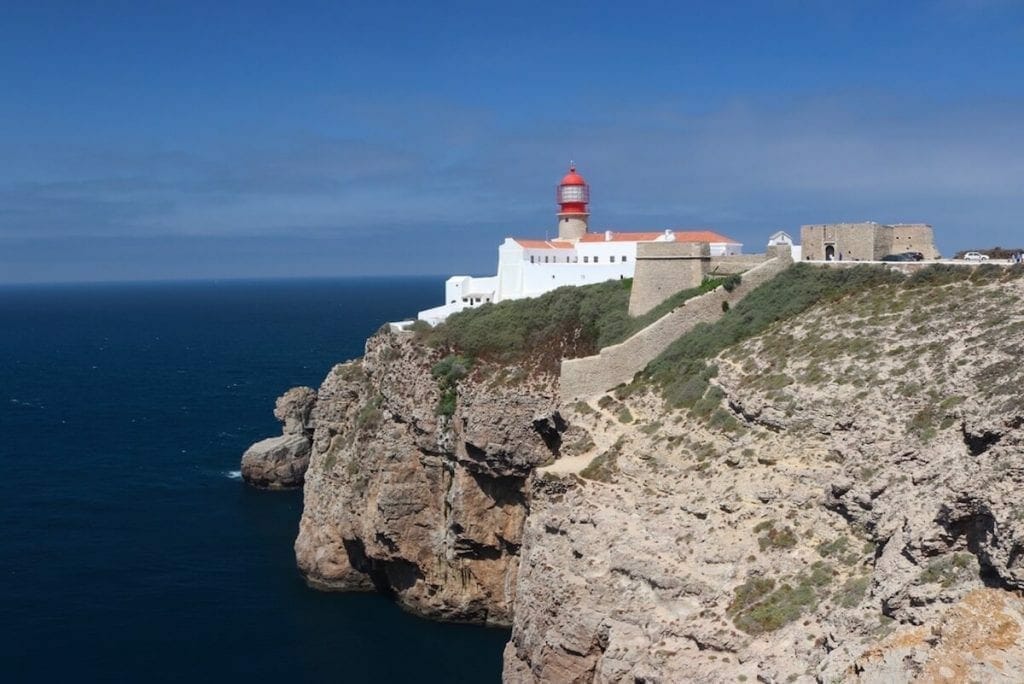 the dramatic sea cliffs of Cape of Saint Vincent and a lighthouse 