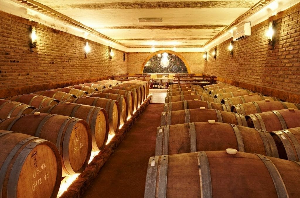a wine cellar with wine barrels