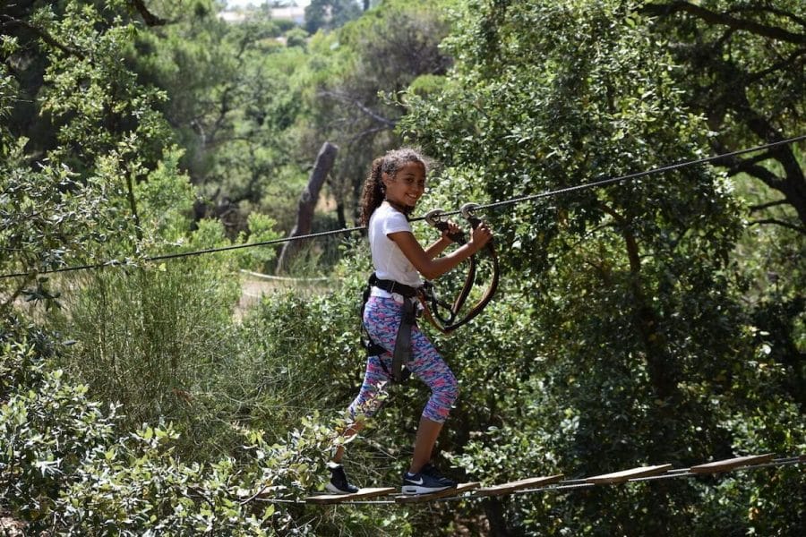 A girl walking on the tree tops at Parque Aventura, Albufeira