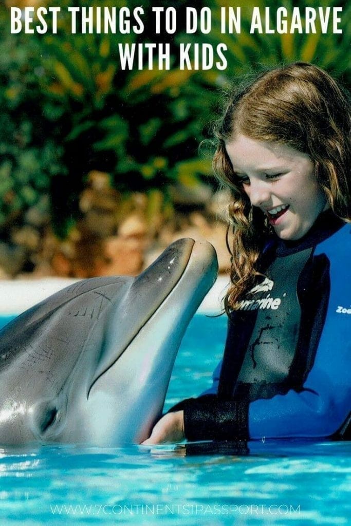 A girl playing with a dolphin at Zoomarine Algarve, Albufeira, Portugal