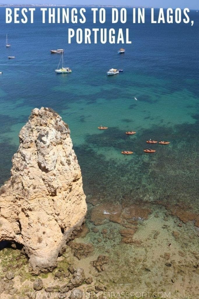 some kaykas and boats sailing in the crystal-clear blue water of Praia Grande, Lagos, Portugal and massive yellow limestone rock in the water