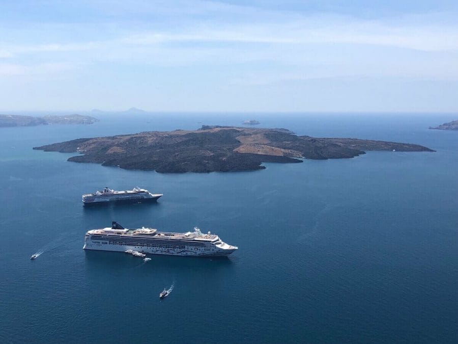 30 Amazing Things to Do in Santorini, Greece 3 Two cruise ships sailing in the Aegean Sea near the island of Nea Kameni, Santorini, Greece