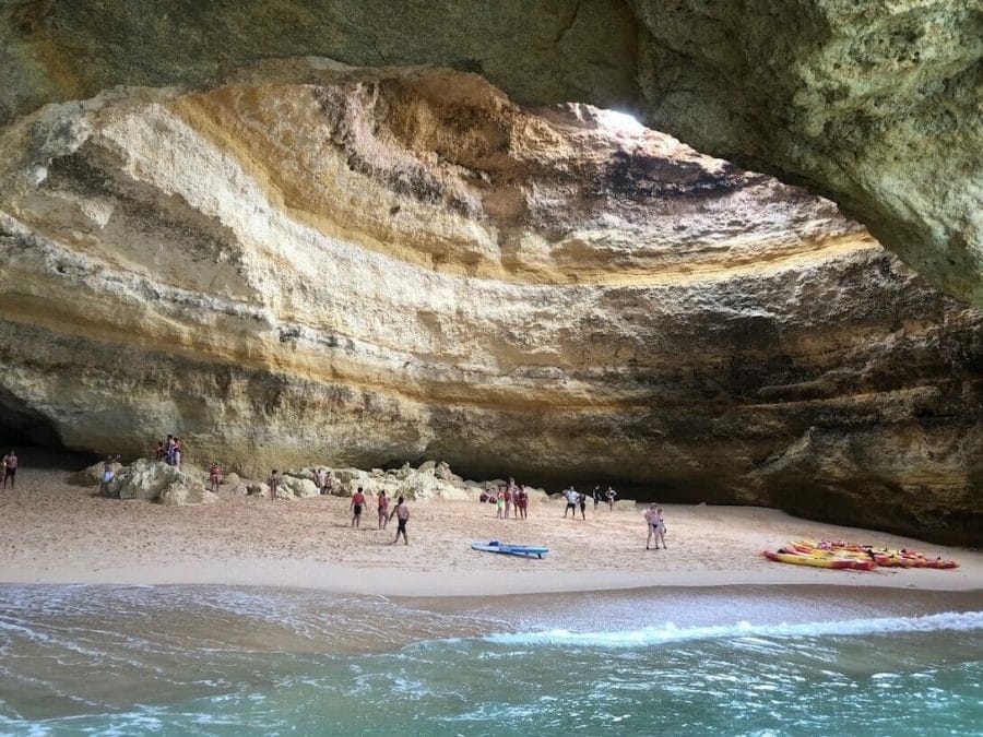 15 Best Algarve Tours, Activities & Excursions For An Unforgettable Trip 4 Some people and kayaks inside Benagil Cave, Lagoa, Portugal