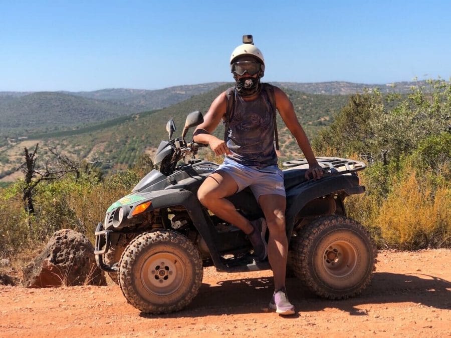 Pericles Rosa wearing a blue tank top, light blue shorts, goggles and a helmet with an ATV during a Quad Bike Tour in the Algarve, Portugal