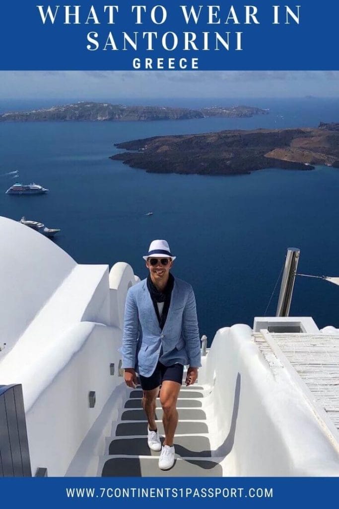What to Wear in Santorini – Best Men's Outfits for Greece 13 Pericles Rosa wearing a white hat, marine-blue scarf, sunglasses, white t-shirt, marine-blue short and white sneakers walking up the stair of the Chromata Hotel in the town of Imerovigli in Santorini, Greece