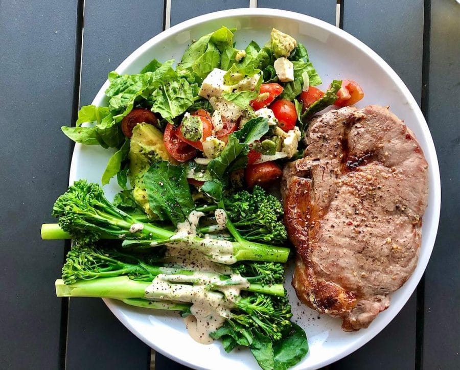 10 Healthy Lifestyle Tips That Everyone Can Follow in 2023 4 A white plate with a piece of meat with broccoli, tomatoes, cheese, avocado and lettuce