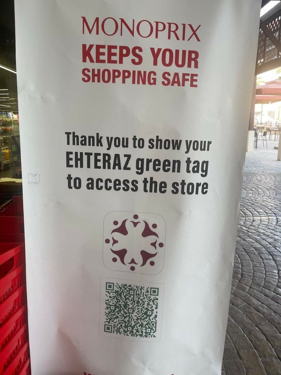 A banner at a Monoprix supermarket in Doha reminding customer to show the Etheraz App