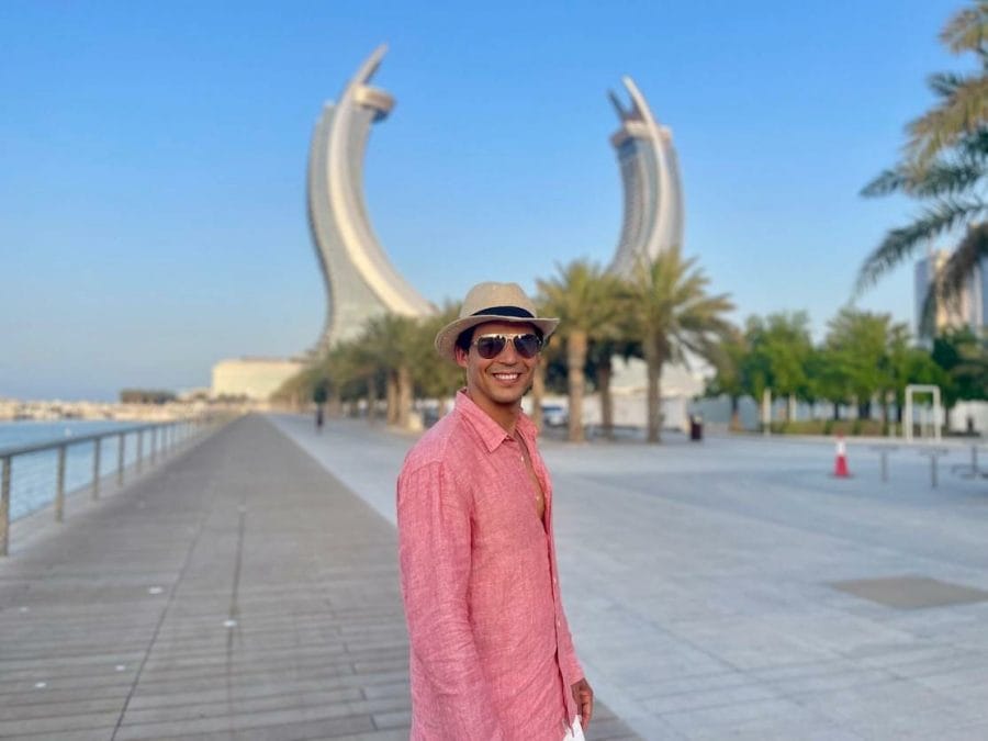 25 Places to Visit and Things to Do in Doha, Qatar 30 Pericles Rosa wearing sunglasses, a hat and a salmon shirt posing for a picture at Lusail Marina Promenade, Qatar