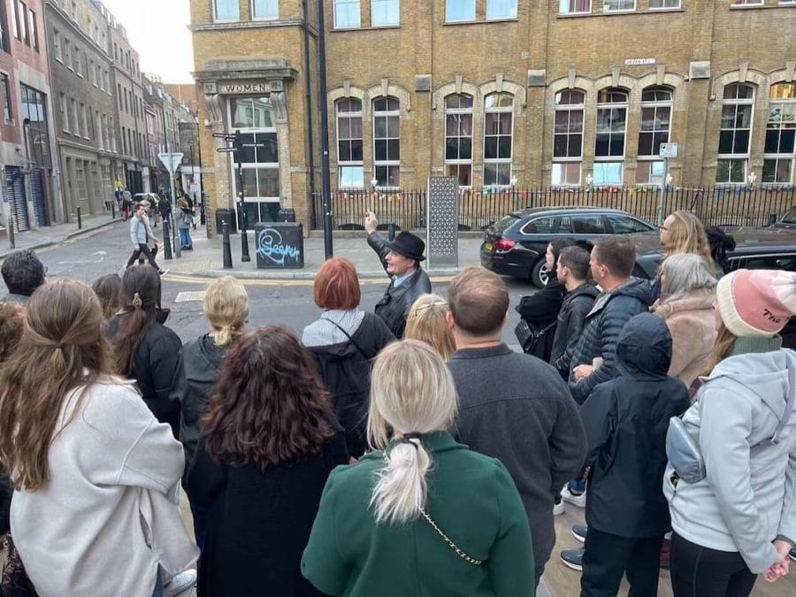 Following the Footsteps of Jack the Ripper - World’s Most (In)Famous Serial Killer 5 A tour guide is showing a building that was a convent to his group tour in Spitalfields, London