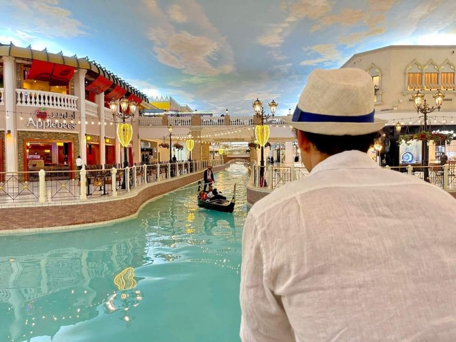A man watiching some people riding a gondola at Villagio Mall, Doha, Qatar