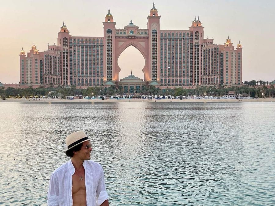 Pericles Rosa wearing a beige hat, sunglasses and a white shirt at The Pointe with the Atlantis The Palm resort in the background, Palm Jumeirah Island, Dubai