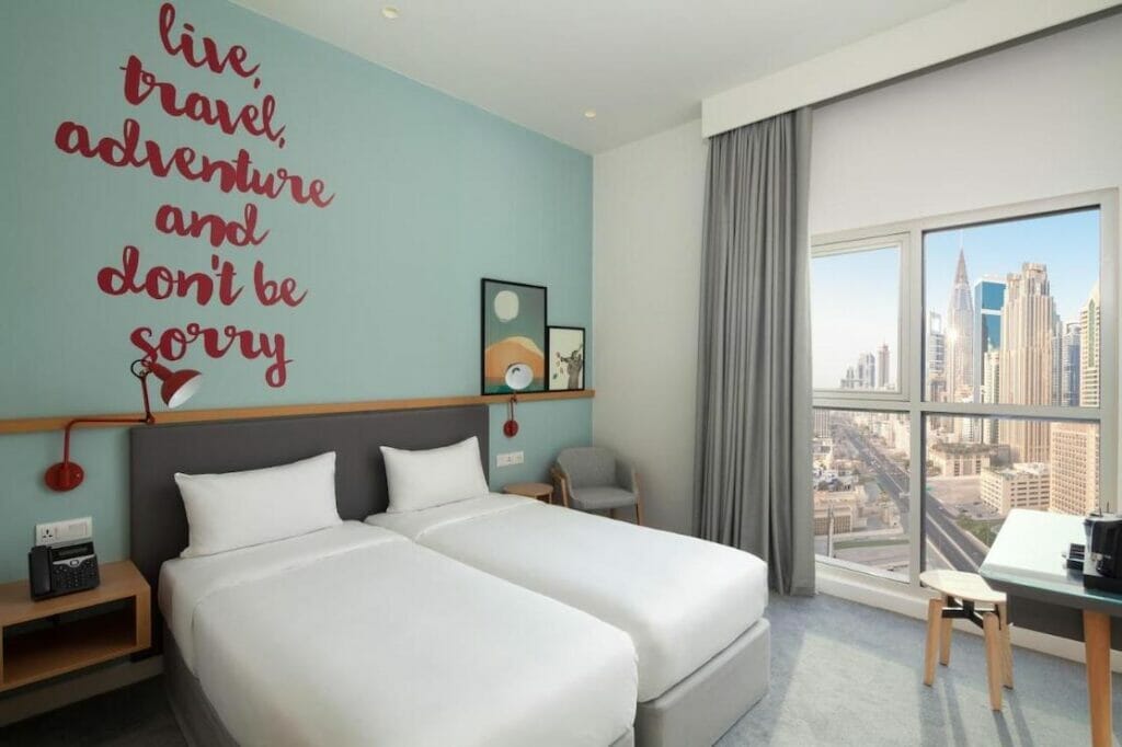 A two single beds room with a city view at Rove City Walk Hotel, Downtown Dubai
