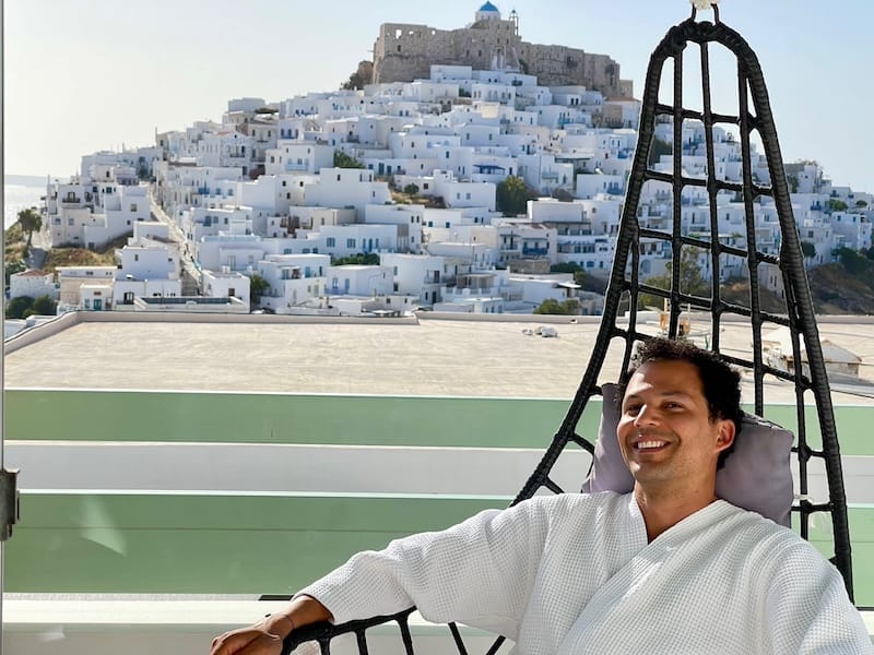 Pericles Rosa siting on a swing chair at Anatoli Luxury Studios and Suites, Astypalea, Greece